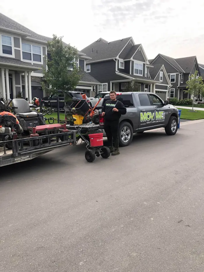 Mow Me truck and mower trailer parked on a townhome street